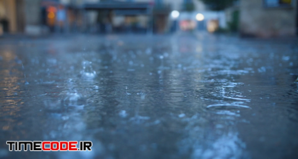 Rain drops in Montpellier streets close up view France slow motion