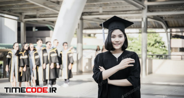 Portrait Of Young Female Graduates In Square Academic Cap Smiling Happy Holding Diploma.