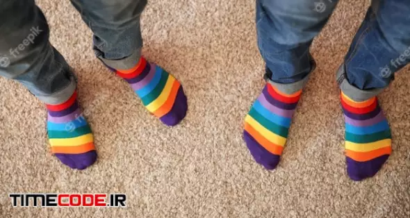 Gay Couple With Colorful Socks Standing On Carpet, Top View 