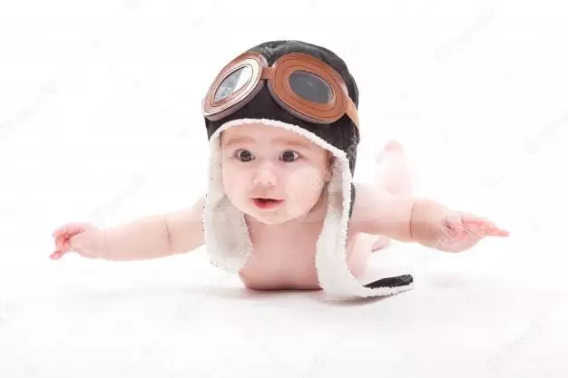 Naked Cute Smiling Baby In The Cap Of The Pilot Is Flying 