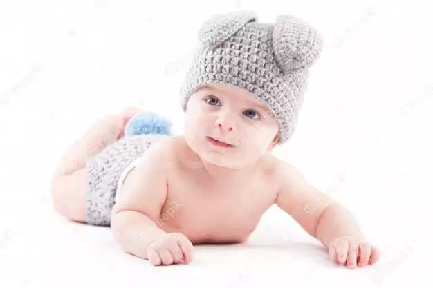 Cute Pretty Baby Boy In Hair Costume Lies On Tummy 