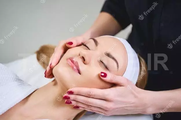 Happy Girl Is Lying On Couch With Closed Eyes While Cosmetologist Is Taking Care Of Her Face 