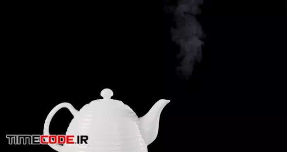 Tea pot on black background with boiling water inside, the steam is rising inthe air. Slow motion footage