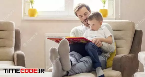 Shallow Focus Shot Of A Father Reading A Children