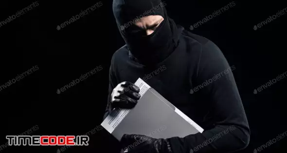 Burglar In Balaclava Holding Top Secret Documents