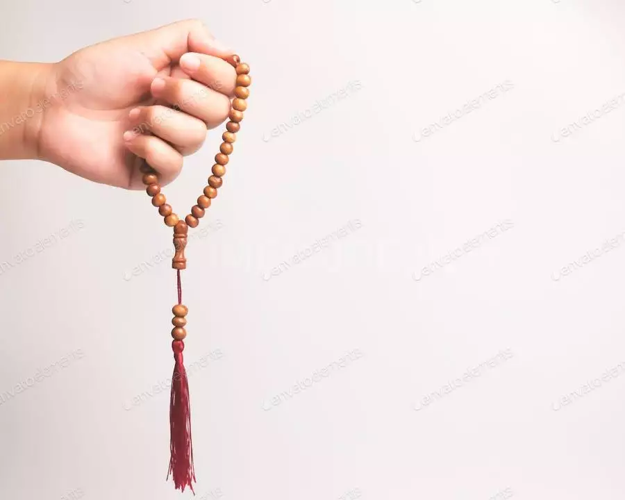 Hand Of Muslim Woman Holding A Prayer Beads