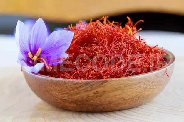 Stigmas Of Saffron And Crocus Flower In A Wooden Plate. Cooking Saffron Spices 