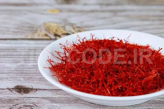 Dry Red Saffron Stamens In A White Plate On A Wooden Background. Saffron Spice.