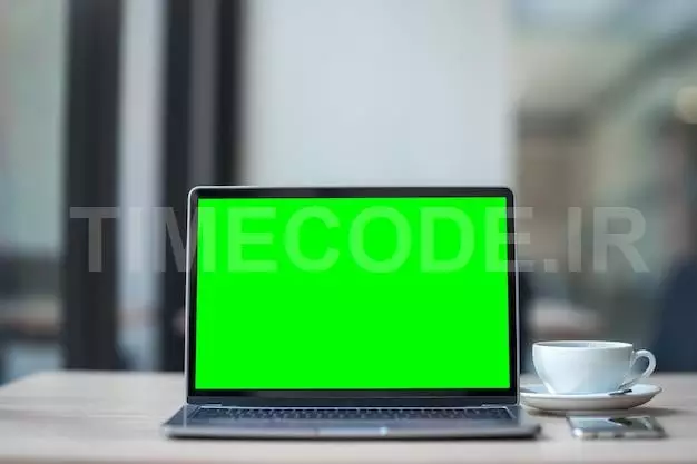 Mockup Of Laptop Computer With Empty Screen With Coffee Cup And Smartphone On Table Of The Coffee Shop Background,green Screen