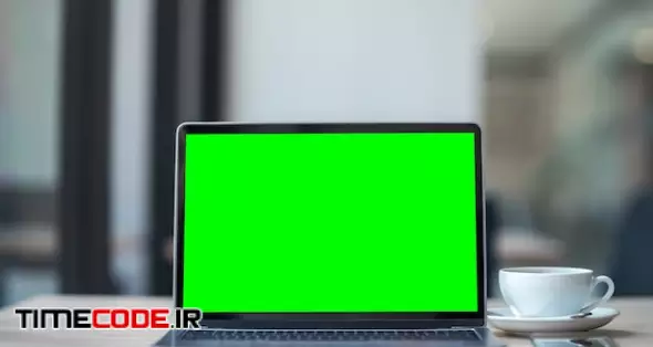 Mockup Of Laptop Computer With Empty Screen With Coffee Cup And Smartphone On Table Of The Coffee Shop Background,green Screen