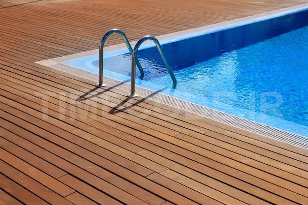 Blue Swimming Pool With Teak Wood Flooring