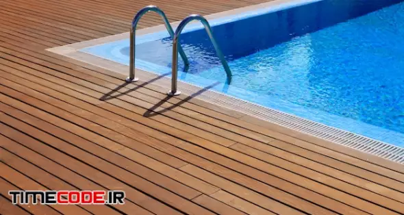 Blue Swimming Pool With Teak Wood Flooring