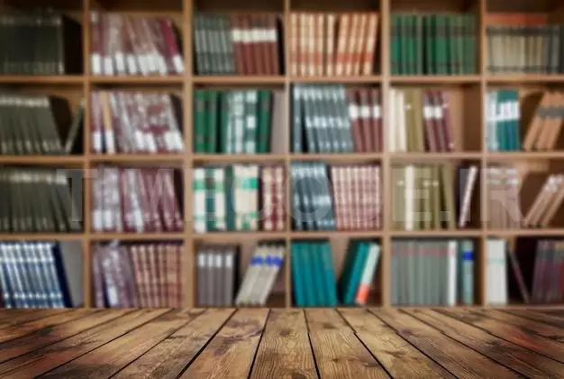 Wooden Tabletop On Blurred Book Shelf Background