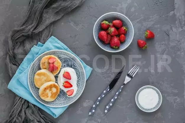 Cottage Cheese Pancakes With Sour Cream And Strawberries For Breakfast Or Lunch On Gray. Top View