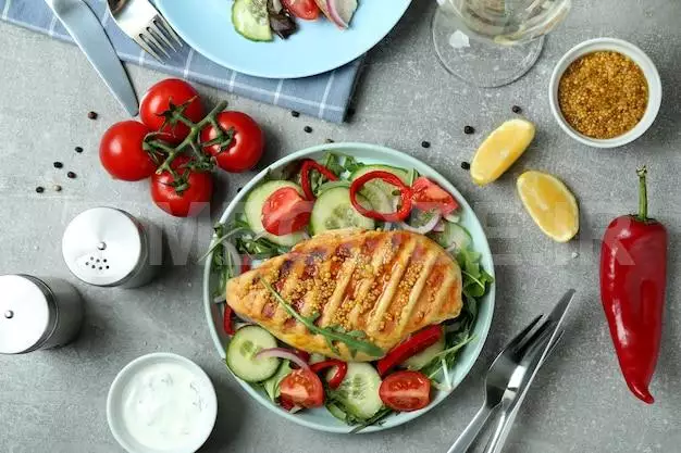 Salad With Grilled Chicken On Grey Table