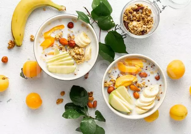 Granola Bowl With Fruits, Nuts, Milk And Peanut Butter