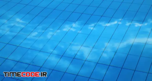 Blue clean water in swimming pool. Clouds are reflected in water 00:20