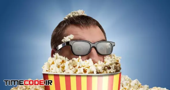 Man In Glasses In A Bucket Of Popcorn Against Blue