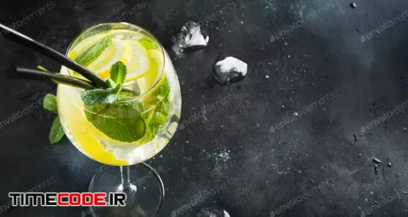 Detox Water Or Lemonade With Lemon And Mint In Glass On Black Table.