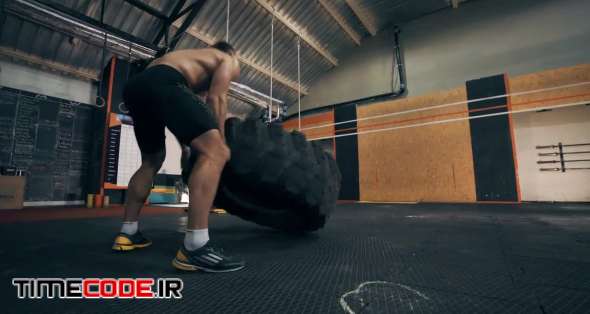Man Working Out With A Tire