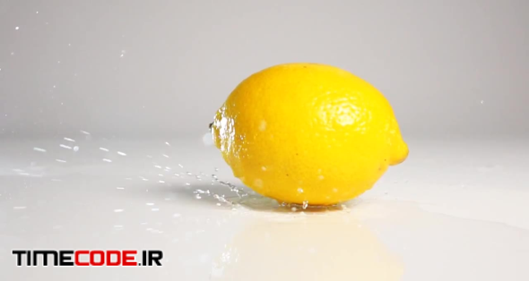Lemon Falling On Wet Surface