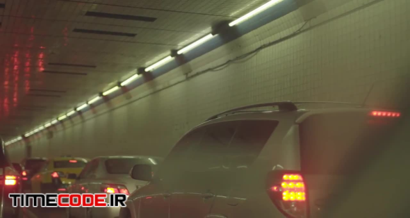 Slow Car Taillights Stuck in Traffic In Busy Tunnel