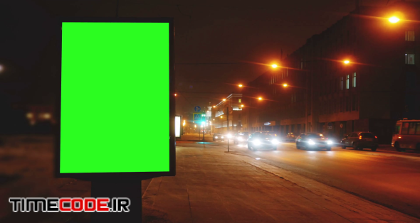 a Billboard With a Green Screen on a Streets