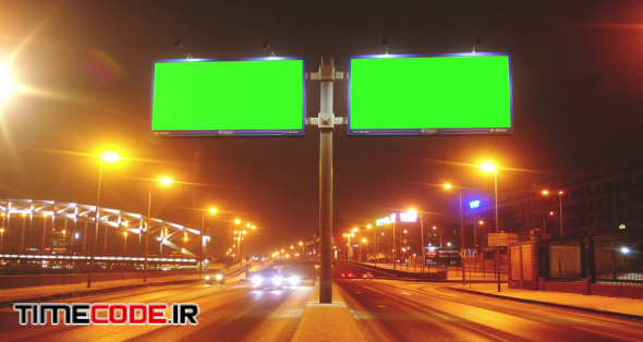 a Billboard With a Green Screen on a Streets