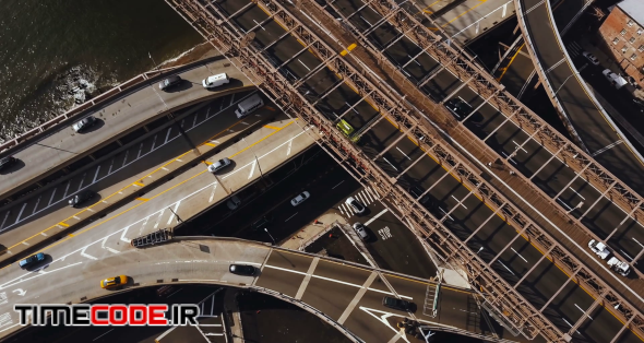 Aerial view of America, New York. Drone flying up over the traffic road, traffic intersection on shore of East river.