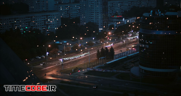 Busy road at night in the city. Top perspective timelapse shot, vehicles rush in both directions, motion blur rendering