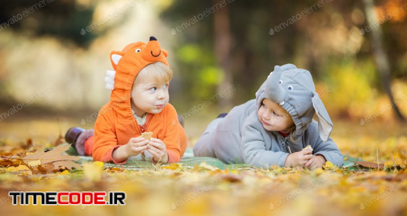 Little Children In Animal Costumes Playing In Autumn Forest