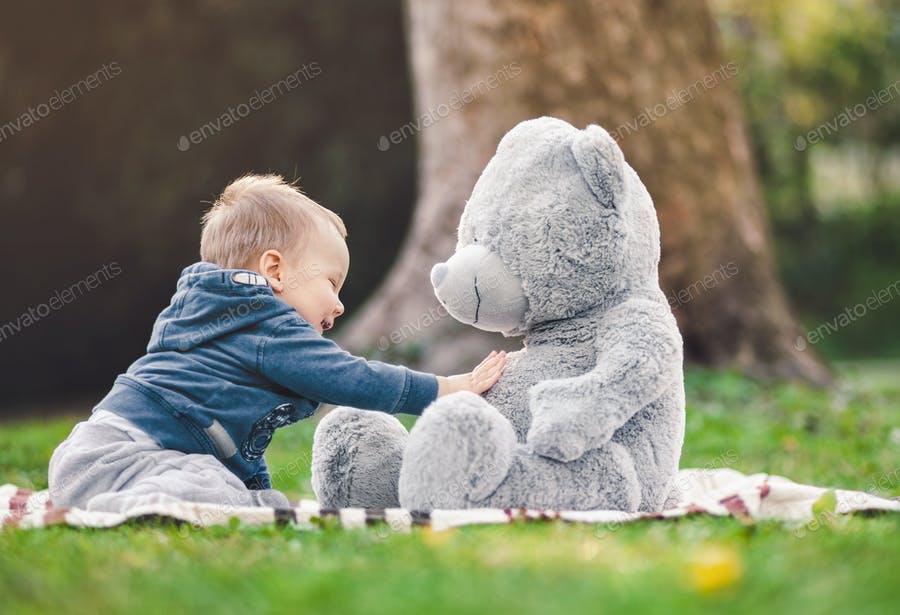 Best Of Friends. Cute Toddler Playing Outdoors With His Teddy Bear