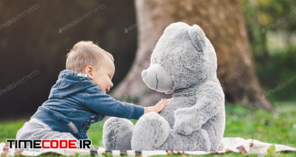 Best Of Friends. Cute Toddler Playing Outdoors With His Teddy Bear