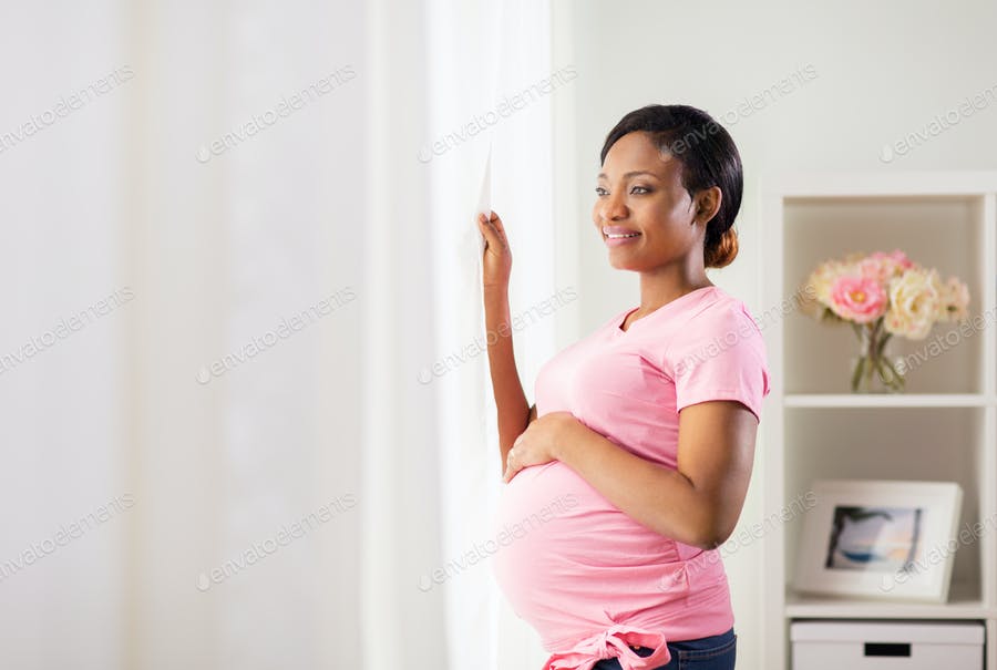 Happy Pregnant Woman With Big Belly At Home