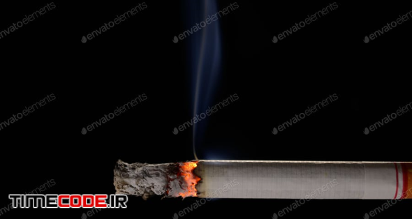 Lit And Burning Cigarette With Smoke On Black Background