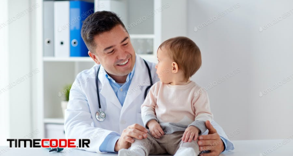 Happy Doctor Or Pediatrician With Baby At Clinic