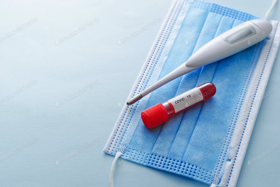 Clinical Thermometer, Tube Of Blood And Face Mask