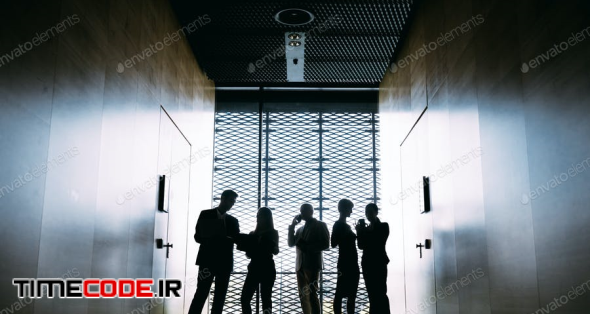 Silhouettes Of Business People In Modern Office Interior