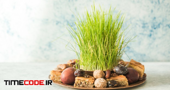 Novruz Traditional Tray With Green Wheat Grass Semeni Or Sabzi, Sweets And Dry Fruits Pakhlava On White Background. Spring Equinox, Azerbaijan Copy Space 